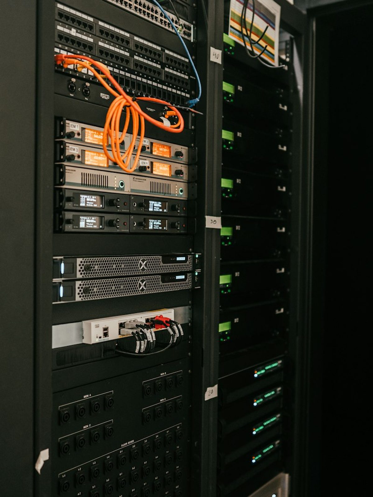 Managed server rack in a data center, network cabling running to a switch.