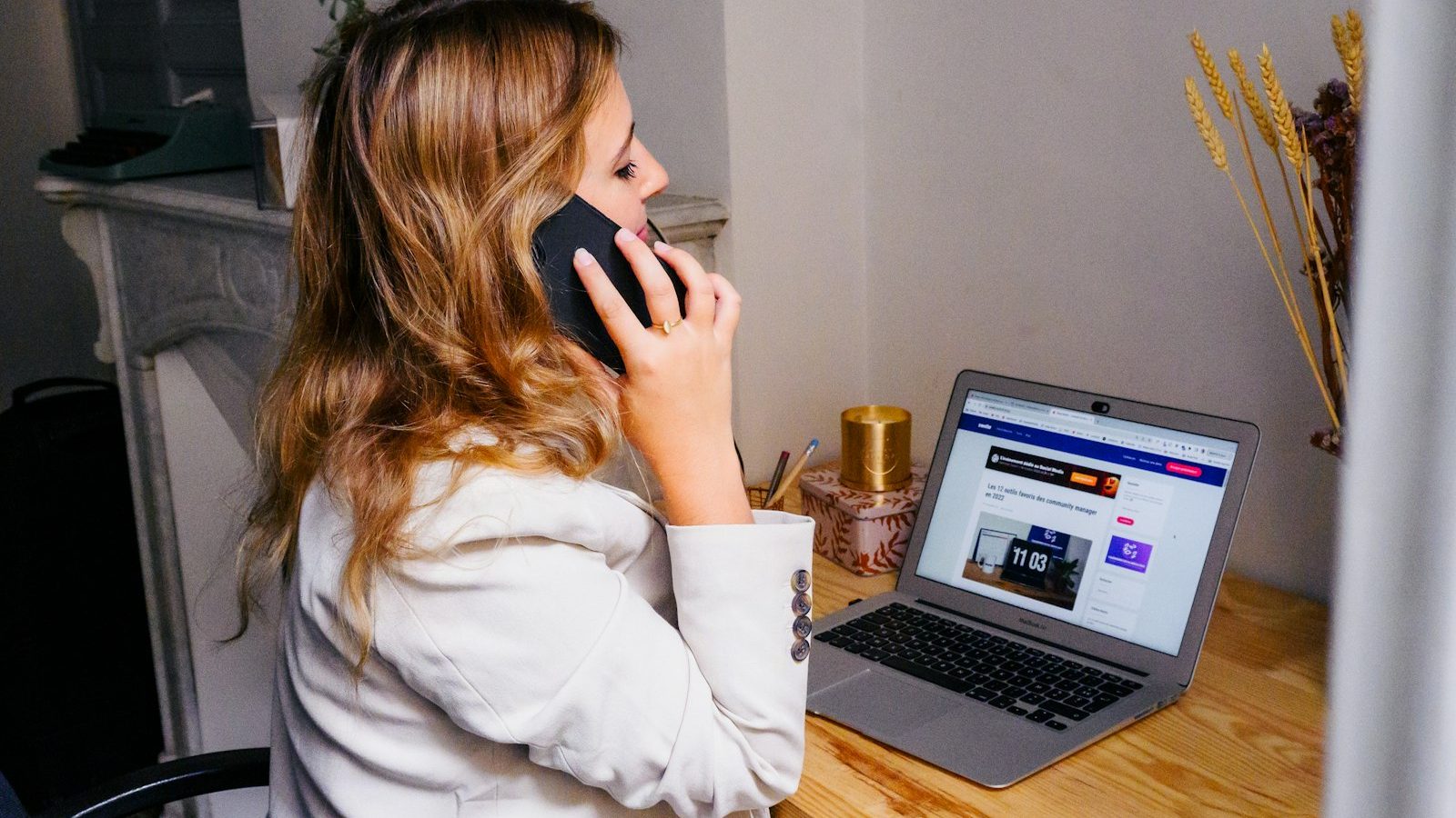 Desk with a laptop and a phone — the setup for a call-first remote session.
